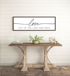 a sign that says love you to the lake and back on a wall above a table