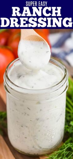 a spoon full of ranch dressing sitting on top of a cutting board