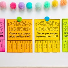 three colorful coupons with pom - poms hanging on the wall next to each other