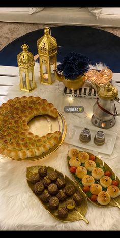 a table topped with lots of different types of desserts and pastries on trays