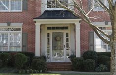 a red brick house with white front door