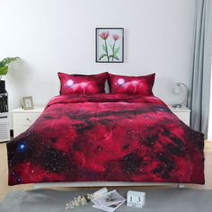 a bed with red and black bedspread in a bedroom