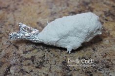 a piece of tin foil sitting on top of a counter next to a white object