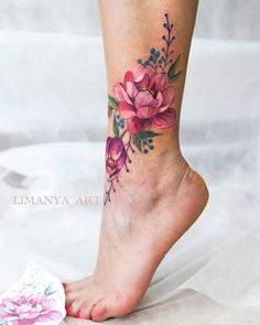 a woman's foot with flowers painted on it