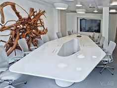 an office with a large white table and chairs