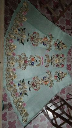 an ornately decorated table cloth on the floor