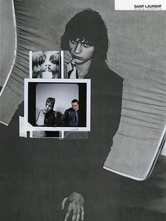 black and white photograph of two people sitting on a couch with pictures hanging from the wall