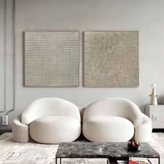 a living room filled with white furniture and art