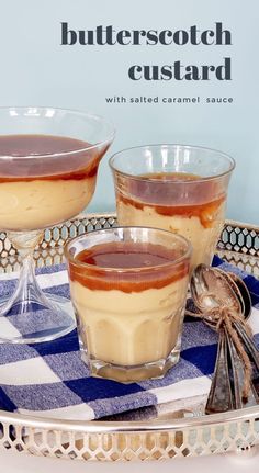 two desserts sitting on top of a metal tray with blue and white checkered cloth