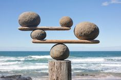 the cover of an instructional book with balancing stones on top of each other and ocean in the background