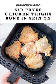 air fryer chicken thighs in a black pan with text overlay