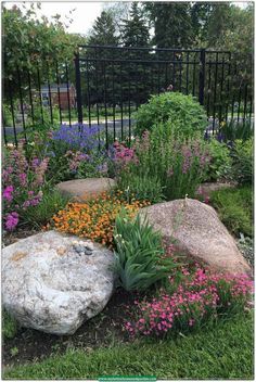 a garden with rocks and flowers in it