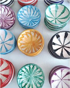 many different colored dishes are arranged in rows