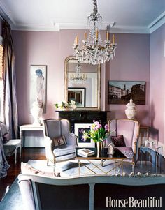 a living room filled with furniture and a chandelier