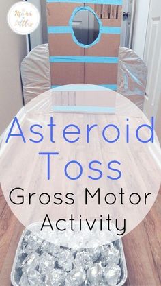 a cardboard box sitting on top of a table with foil wrapped around it and the words, asteroid toss gross motor activity