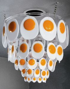 an egg chandelier with orange and white eggs hanging from it's ceiling