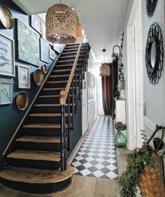 a hallway with stairs and pictures on the wall