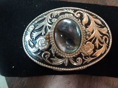 a belt buckle with an oval stone in the center