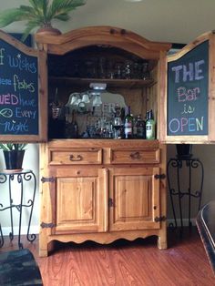 a wooden hutch with chalkboard menus on it