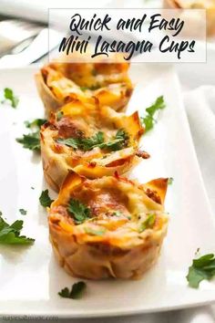 three mini lasagna cups on a white plate with parsley garnish