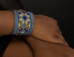 Geometric Cuff Embroidered Bracelet for Women, Textile Blue Background, Boho Bracelet, Bracelet for Women Stylish bracelet with soothing color of Blue that you can easily match with your outfit. It will surely add to your style. The bracelet is hand made needle work with 100% natural thread, all environmentally friendly material (100% cotton and brass, NO plastic) for people that we share our concern about environment with. One item takes days and days of needlework. The artistic patterns inspir Multicolor Embroidered Bangle Jewelry, Adjustable Artisan Blue Bangle, Artisan Blue Cuff Bangle Bracelet, Artisan Blue Bangle Cuff Bracelet, Blue Artisan Cuff Jewelry, Artisan Blue Cuff Bracelet, Artisan Blue Cuff Jewelry, Blue Cuff Bracelet Gift, Traditional Adjustable Blue Bangle