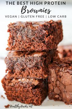 two chocolate brownies stacked on top of each other with one piece cut in half