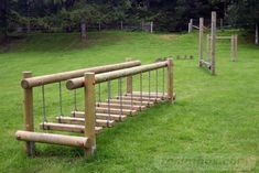 a wooden bench sitting on top of a lush green field next to a soccer goal