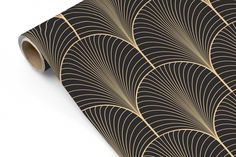 an art deco wallpaper with black and gold fan design on it's side