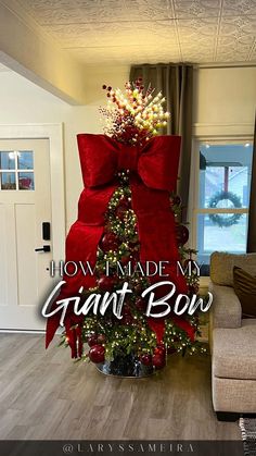 a decorated christmas tree in the middle of a living room with red bows on it