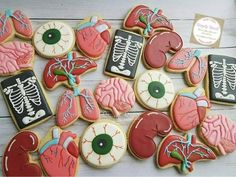 cookies decorated with different types of medical items on a white table top, including an x - ray and heart