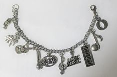 This listing is for 1 Stainless Steel Cable Chain Charm bracelet with a MAXIMUM OF ELEVEN (11) Nickle free zinc alloy charms. You may select charms from Lists A, B or C. When selecting charms please be sure to designate which list you have selected from, for example. (Charm #1A, #2B or #3C) IF YOU WANT TO ADD MORE THAN 11 charms, please send me a message PRIOR to ordering so that I can set up a custom listing for you. Each additional charm is $.75 each ANY ORDERS FOR BRACELETS THAT HAVE MORE THA Silver Band Bracelets For Concerts, Silver Bracelet For Concerts, Silver Bracelet Jewelry For Concert, Silver Band Jewelry For Concert, Silver Band Jewelry For Concerts, Music-themed Band Jewelry As Gift, Music-themed Band Jewelry Gift, Silver Metal Bracelets For Concert, Silver Metal Bracelets For Concerts