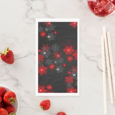 a table topped with strawberries next to a bowl of strawberries and chopsticks