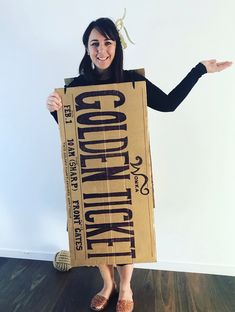 a woman is holding up a cardboard sign