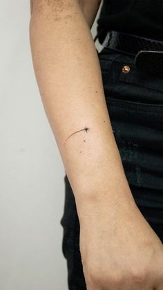 a person with a small star tattoo on their arm