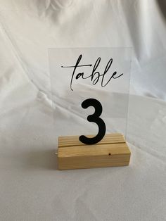 a wooden block with a table number on it and a sign that says table 3