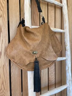 Beautiful top grain raw leather ( no lining) crossbody/shoulder bag. Slouch hobo bag with tons of room. Two straps, one crossbody and one hand or shoulder strap. All detachable. Hand/shoulder strap has a hand stitched finish as does the main body of the bag. It has a twist style metal fastener and a large leather tassel.  All of my bags are designed and made by me, all one of a kind.  I do not replicate! Raw Leather, Twist Style, Leather Tassel, Robins, Top Grain Leather, Hobo Bag, Hand Stitched, Crossbody Shoulder Bag, Hand Stitching