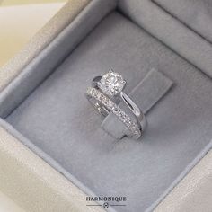 a close up of a ring in a box with a diamond on the bottom and side