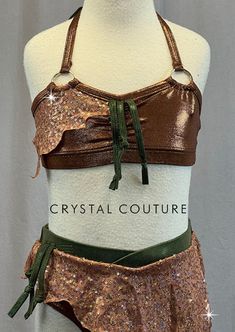 Copper shimmer halter bra top has metal rings on straps and Olive Green thick fringe. Trunks have asymmetrical zsa zsa skirt with jagged edge. *Accessories Include: Wrist Cuff, Two Fringe Arm Bands, and Fringe Waist Band. **Costume in image is a YM, Photographed on a YM/YL Mannequin with Measurements of: Bust 27", Waist 24", Hip 27", Girth 47". Thick Fringe, Trio Costumes, Sequin Jewelry, Halter Bra Top, Costumes Couture, Green Two Piece, Jagged Edge, Zsa Zsa, Halter Bra