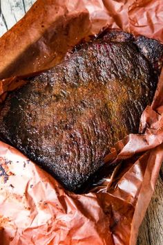 a piece of meat sitting on top of some brown paper