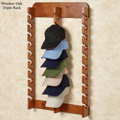 a hat rack with five hats hanging on it's sides and the top shelf is made out of wood