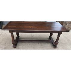 a large wooden table sitting on top of a carpeted floor