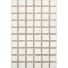 a white rug with grey squares on it