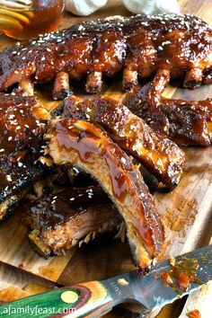 ribs covered in bbq sauce on a cutting board