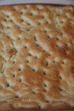 a close up of a square pastry on a plate with other items in the background