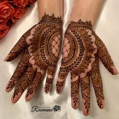 two hands with henna designs on them