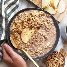 a bowl of oatmeal with apple slices on top