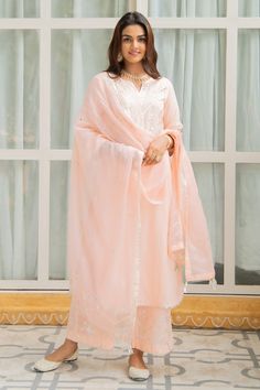 Peach straight long kurta with gota and mirror hand detailing on the neckline, sleeves - hemline and chevron pattern. Comes with sheer kota doria dupatta with handmade gota tassels and straight fit cotton pants enhanced with silver gota work.
Component: 3
Embroidered
Neckline: V Neck
Sleeve Length: Three Quarter
Fabric: Cotton, Kota Doria
Color: Peach
Split neck
Chevron pattern
Side slits
Cutwork trims - Aza Fashions Long Kurta, Kurta Set For Women, Gota Work, Embroidered Neckline, Cotton Embroidery, Fashion App, Kurta Set, Cut Work, Chevron Pattern