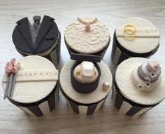 wedding cupcakes are arranged on top of each other in black and white stripes