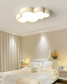 a bed room with a neatly made bed and lights