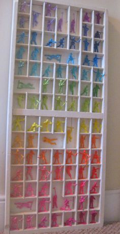 a white shelf filled with lots of different colored plastic figures